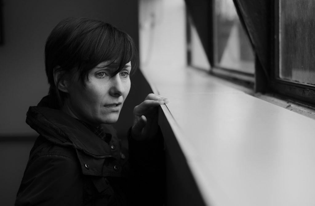 3 Steps for When You Know Something Bad Is Coming_black and white_anxious woman with short hair looking out a window