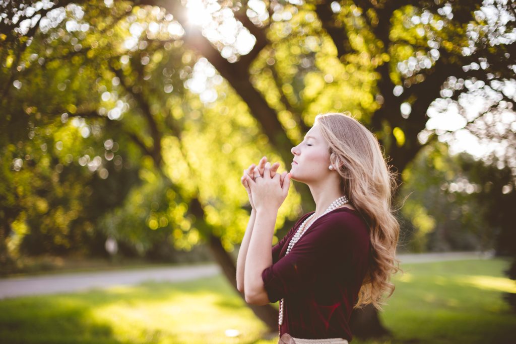 A Thanksgiving Prayer_woman standing by trees, praying eyes lifted to heaven