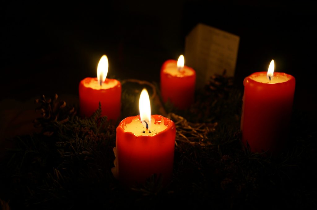 When You Need to Know There's More to Christmas than Empty Boxes_advent wreath with red candles, lit long, dripping wax, card in background